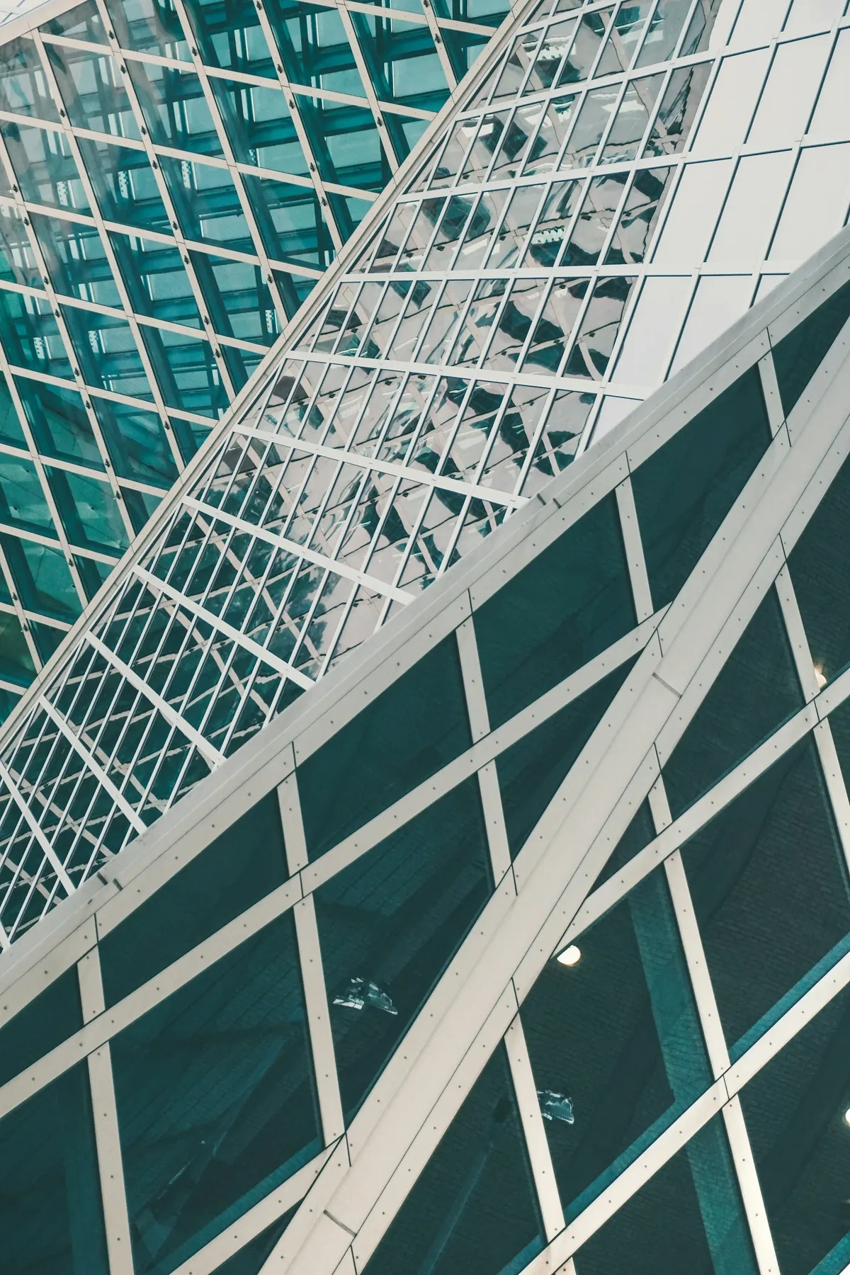 Geometric glass and steel office facade seen from below